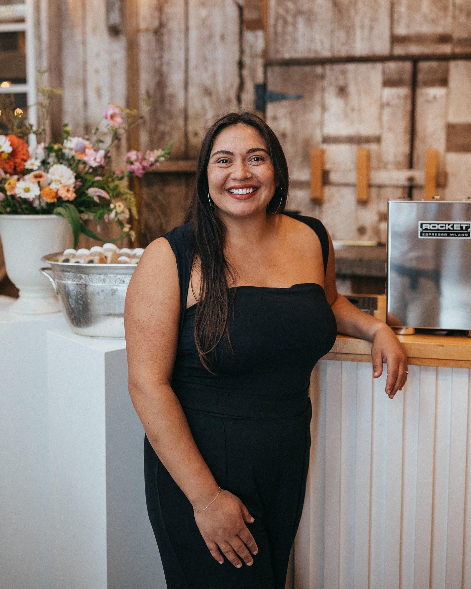 The owner of Cafecito Sol beside the espresso bar